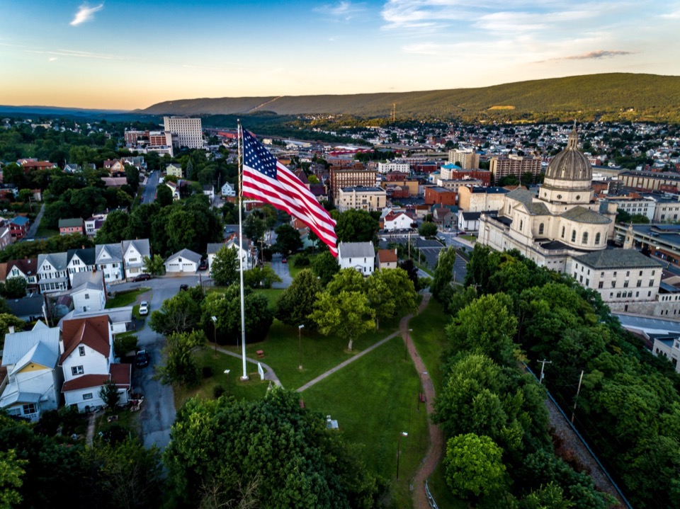 Aerial view of Altoona, Pennsylvania with the American flag and downtown skyline